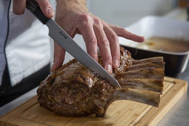 Tagliare la carré di vitello alla francese a fette.