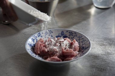 Infarinare la carne di vitello con farina per tempura su tutti i lati.